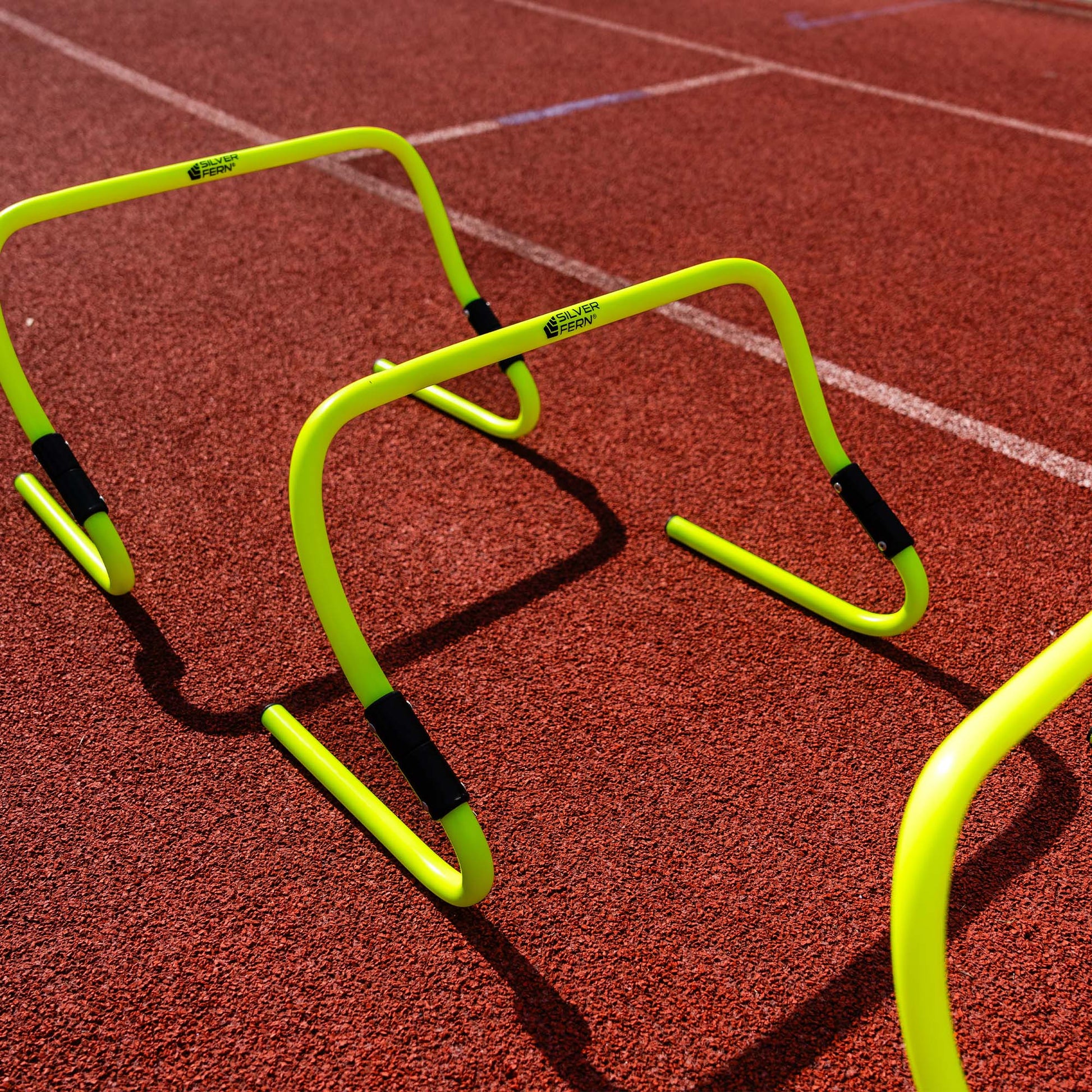 A set of Adjustable Agility Hurdles, placed on an Athletics track.