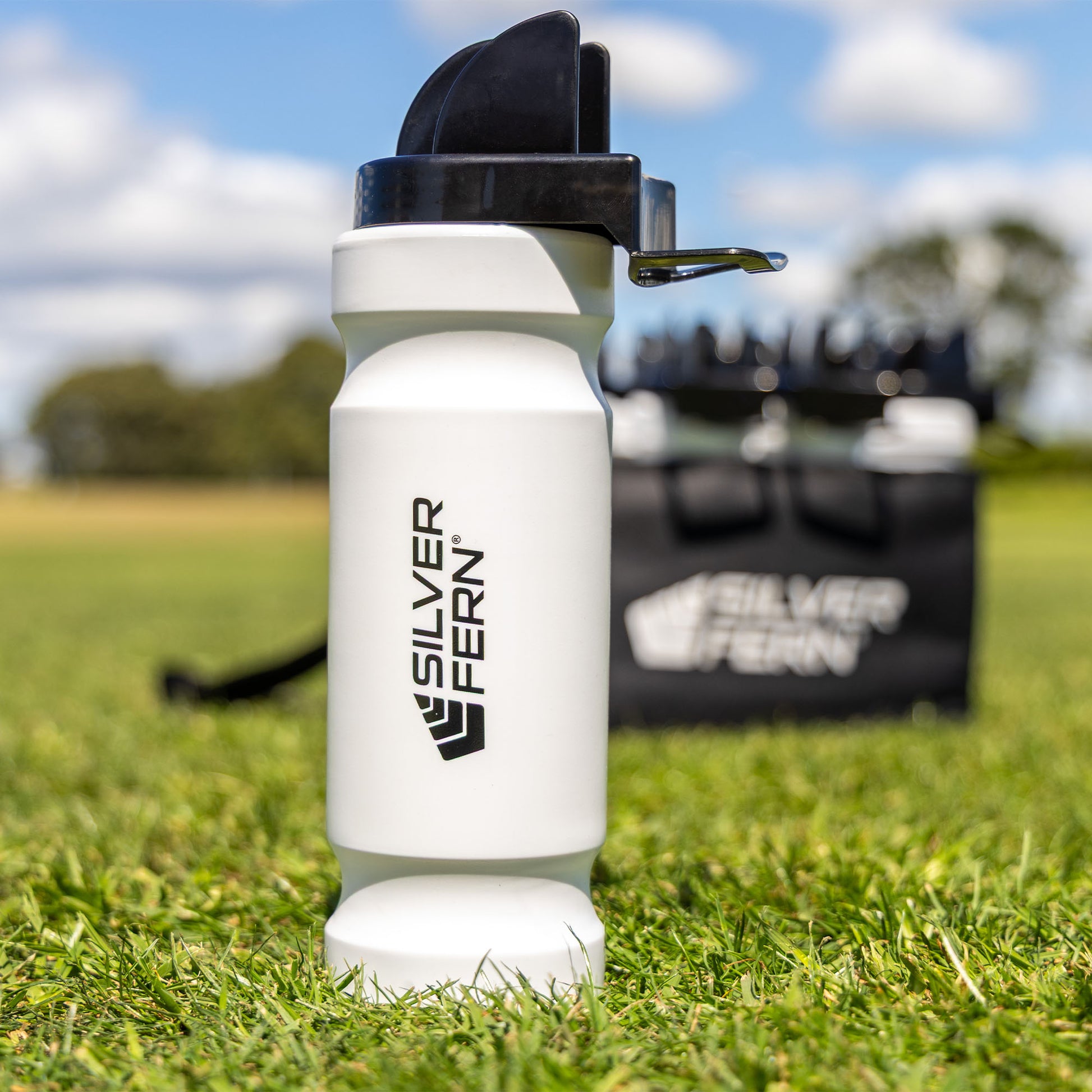 Hygiene drink bottle, lifestyle shot, drink bottle on its own sitting on the grass. 